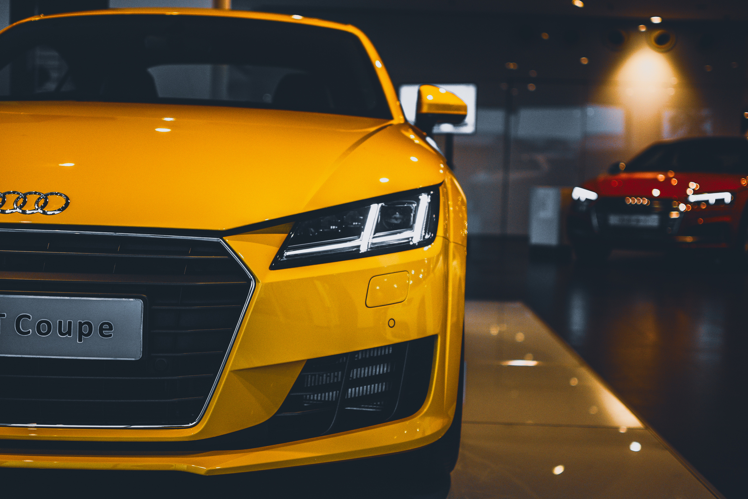 Shiny Yellow Audi Car in Showroom